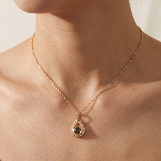Woman wearing the LevNSoul gold-tone memorial photo projection necklace at the collarbone