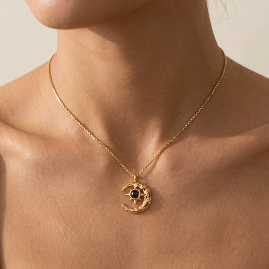 Woman wearing the LevNSoul gold-tone crescent moon photo projection necklace at the collarbone