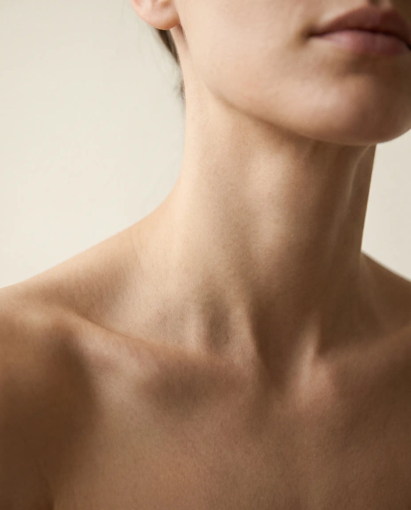 Close-up of a neck and collarbone wearing no jewellery